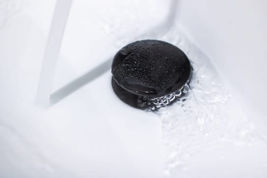 Imagine a black hole located in a sink where water is continuously running out of it, creating an intriguing optical illusion of plumbing malfunction