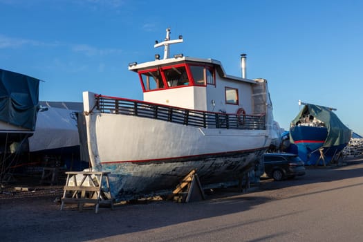 Boat stored out of the water for the winter, winter storage for the boat in Finland, Suomenoja, winterizing , short season in Northern country, cold conditions