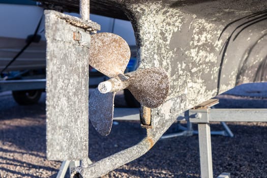 The propeller and bottom of boat covered with Acorn barnacles (Semibalanus balanoides), ready to be scraped, cleaned and coated with antifouling paint for yachts, Many shells on the boat