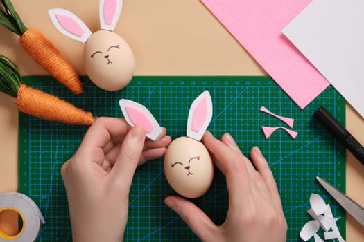 DIY Easter Bunny Egg Craft. Step-by-step instructions. Glue the ears to the egg with double-sided tape.