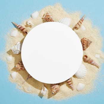 Round frame made of white sand and various white and brown shells on a light blue background. A space for your text.