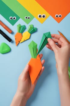 Making origami carrot. DIY project. Insert the resulting leaves into the orange part of the carrot.