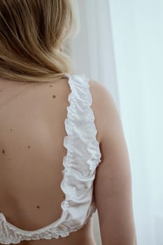 view from the back, top shawl on girl. white silk top and girl's back.