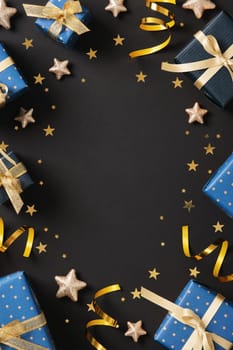 Vertical frame made from gift wrapping supplies. Blue wrapping paper, gold ribbons, tags, scissors, confetti. Space for your text.