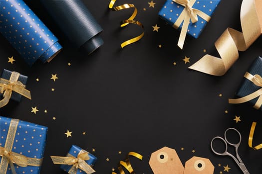 Horizontal frame made of gift wrapping materials. Blue wrapping paper, tags and gold colored ribbon. Space for your text.