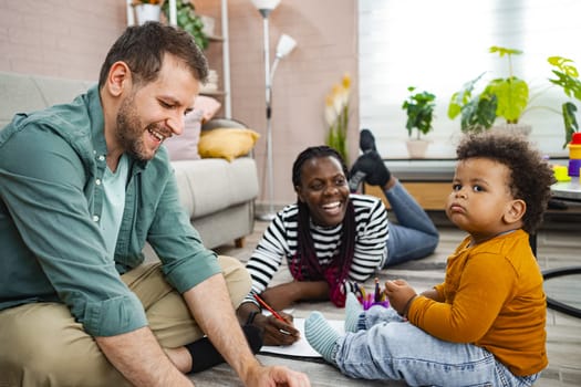 A joyful family engages in artistic activities indoors.