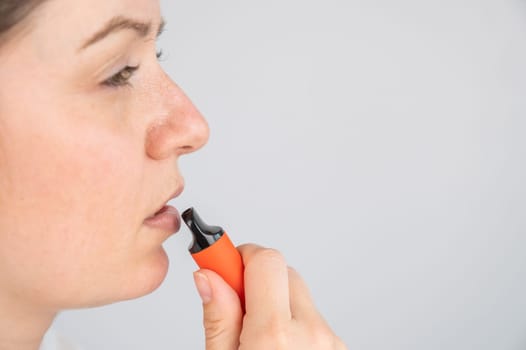 Caucasian woman smoking disposable vape