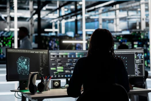 Server room engineer using artificial intelligence to enhance operational efficiency and reduce downtime. Admin AI driven solutions for data center infrastructure using node trees on PC