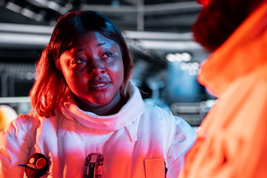 Team of spaceship engineers following danger protocol to fix security breach causing overload warning. Space station coworkers repairing critical systems after asteroids debris impact