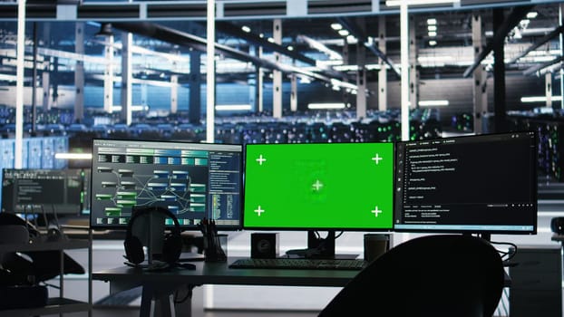 Chroma key computer displays in data center workplace used for managing supercomputers hardware energy consumption. Green screen PC used for automation in server hub workplace