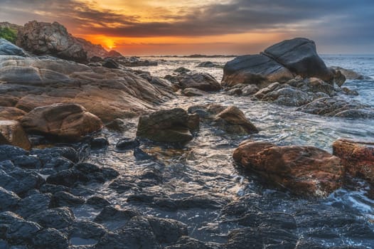 Panoramic landscape with volcanic basalt columns Ganh Da Dia on the beach by sea. Da Dia reef in Vietnam at sunrise