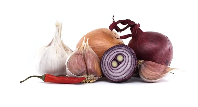 A collection of fresh garlic bulbs, onions, and a chili pepper displayed against a simple white background, showcasing natural ingredients often used in cooking.