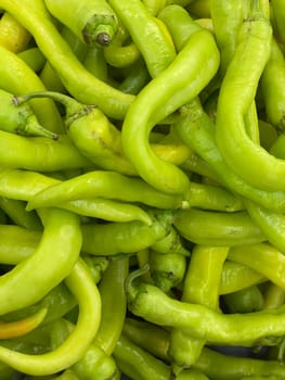 lots of green chili peppers for cooking as background