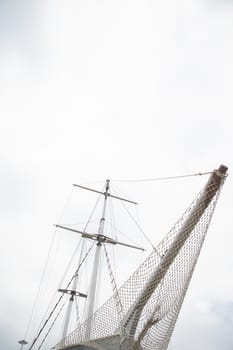 masts of a wooden ship in the roadstead