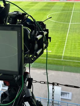Cameraman's video camera for shooting football at the stadium