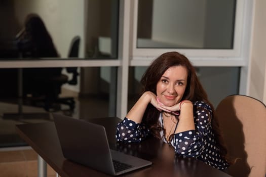 Business woman working on laptop online at desk in office