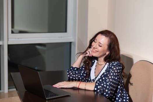 Business woman working on laptop online at desk in office