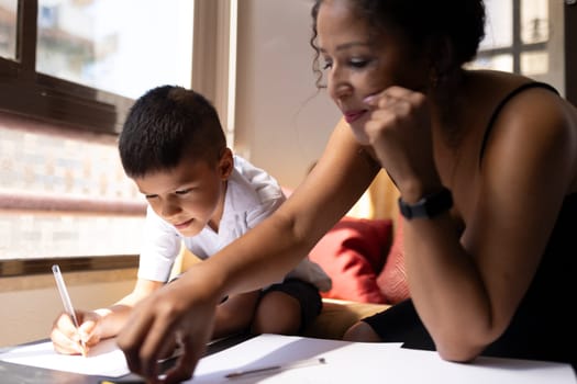 Mother assisting her son with homework, fostering a positive learning environment at home