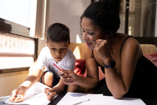 Mother assisting her son with homework, fostering a positive learning environment at home