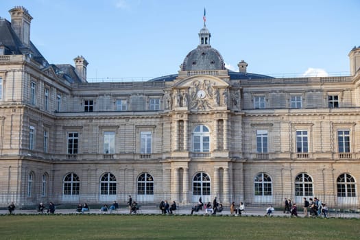 Paris, France - February 22, 2025: A scenic view of the Luxembourg Garden (Jardin du Luxembourg) in Paris. Classic Parisian public park chairs, visitors relax near the central fountain