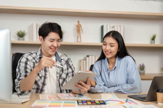 A dynamic exchange between two designers as they evaluate UX and UI elements, fostering creativity in a modern workspace.