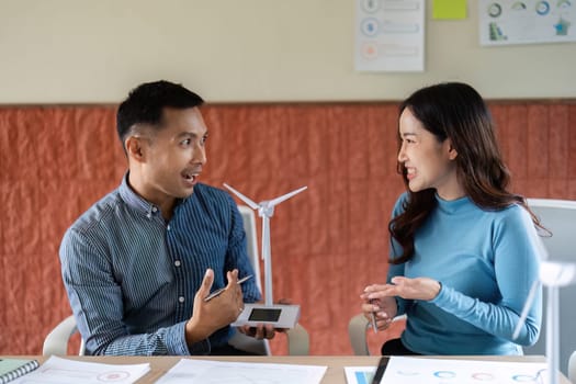 A man and woman discussing ESG strategies with enthusiasm, highlighting collaboration and innovative thinking.