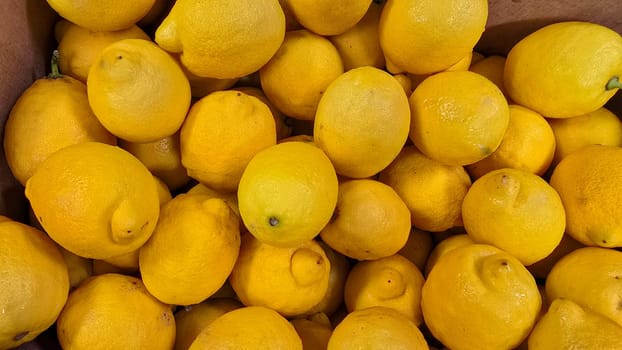 Bright yellow lemons grouped together, presenting an inviting and fresh appearance suitable for culinary or beverage uses, evoking sunny and refreshing vibes. Lemon stack. A vibrant image of fresh, ripe lemons top view. Rich vitamin c, natural and fresh lemon stack