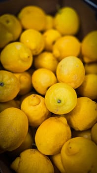 Bright yellow lemons grouped together, presenting an inviting and fresh appearance suitable for culinary or beverage uses, evoking sunny and refreshing vibes. Lemon stack. A vibrant image of fresh, ripe lemons top view. Rich vitamin c, natural and fresh lemon stack