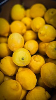 Bright yellow lemons grouped together, presenting an inviting and fresh appearance suitable for culinary or beverage uses, evoking sunny and refreshing vibes. Lemon stack. A vibrant image of fresh, ripe lemons top view. Rich vitamin c, natural and fresh lemon stack