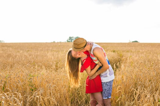 Young couple in love outdoor.Stunning sensual outdoor portrait of young stylish fashion couple posing in summer in field