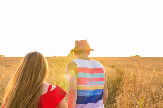 Young couple in love outdoor.Stunning sensual outdoor portrait of young stylish fashion couple posing in summer in field