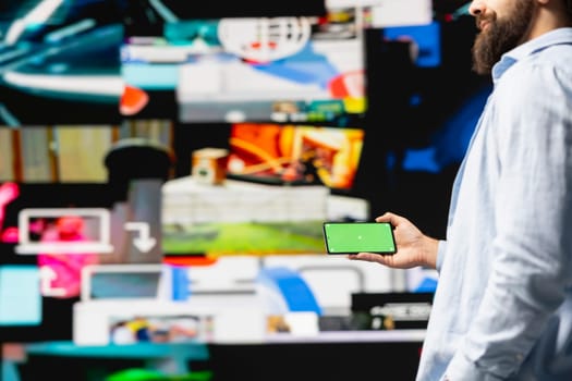 Young influencer checks phone with mockup screen for activity on social media platforms, leveraging innovation and mobile technology to maintain engagement and build a community. Social network.