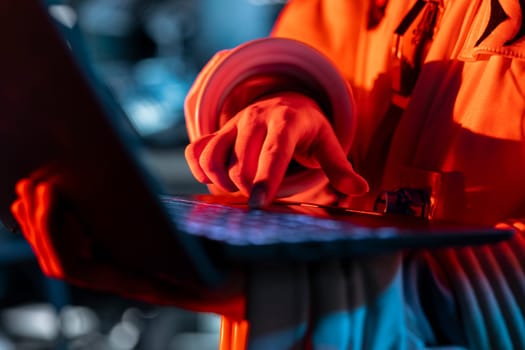 Close up of spaceship engineer typing on laptop, fixing security breach causing alarm to sound. Space station technician pressing notebook keys, repairing system failure triggering emergency lights