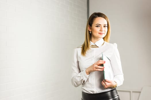 Portrait of business woman hold a folder.