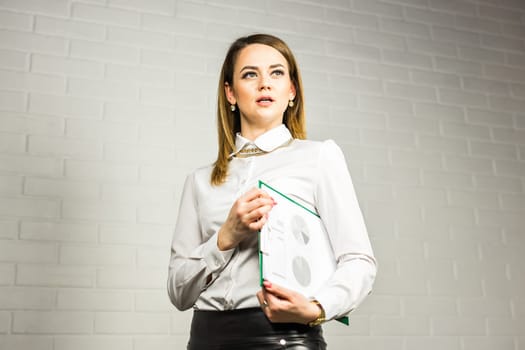 Portrait of business woman hold a folder.