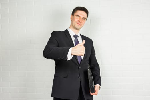 Smiling businessman with thumb up. Happy businessman thumbs up sign on white background