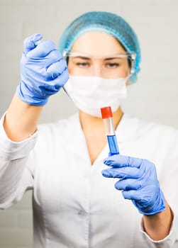 Attractive young female scientist working in laboratory.