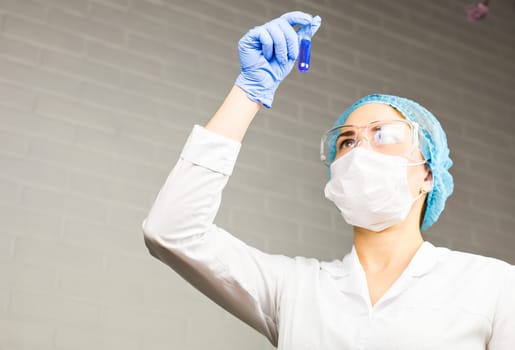 Attractive young female scientist working in laboratory.
