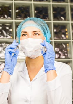 Attractive young female scientist working in laboratory.