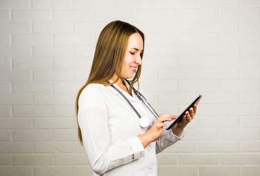 healthcare, technology and medicine concept - smiling female doctor with stethoscope and tablet pc computer