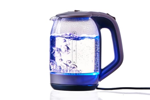 Glass electric kettle with boiling water on a white insulated background. High quality photo