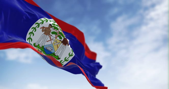 Belize national flag waving in the wind on a clear day. Blue field, red stripes top and bottom, white disk with National Coat of Arms. 3d illustration render. Fluttering fabric