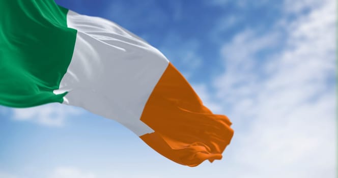 Ireland national flag waving in the wind. Vertical tricolour of green, white, and orange. European Union state member. 3d illustration render. Fluttering fabric. Selective focus.