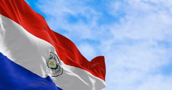 Close up of Paraguay flag waving. Three equal horizontal bands of red, white and blue with an emblem centered in the white band. 3d illustration render. Selective focus. Fluttering fabric. Patriotism