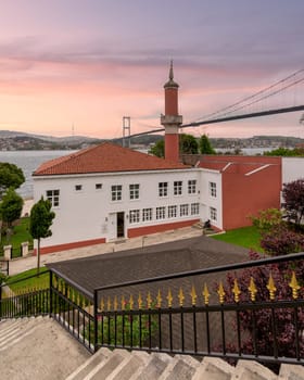 Old Ottoman Defterdar Ibrahim Pasa Mosque, located at the European side of Bosphorus strait at Besiktas district, with 15 July Martyrs Bridge in the background, Istanbul, Turkey
