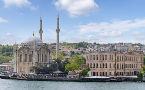 Istanbul, Turkey - May 8, 2023: View from Bosphorus Strait overlooking Ortakoy Mosque and redeveloped Esma Sultan Mansion, currently a Cultural center, Ortakoy pier square