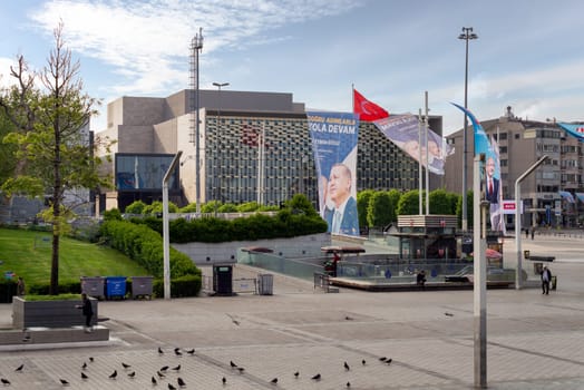 Istanbul, Turkey - May 13, 2023: Taksim Square, or Taksim Meydani one day before the 2023 presidential elections, with banners supporting candidates and Ataturk Cultural Center in the background