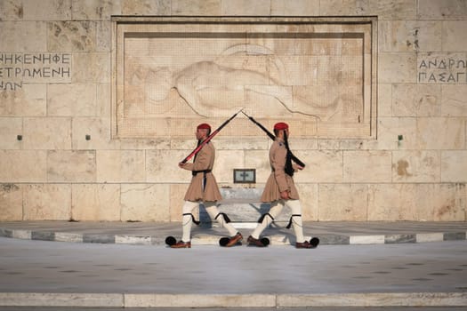 Ceremony of Presidential guard Evzones by the Greek tomb of Unknown Soldier. Evzones in summer uniform walk away from each other. Close shot.