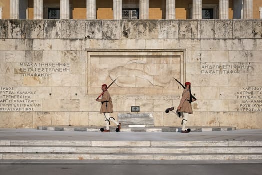 Ceremony of Presidential guard Evzones by the Greek tomb of Unknown Soldier. Evzones in summer uniform separate . Wide shot.