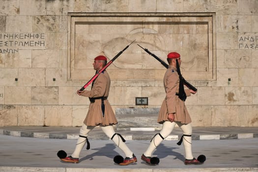 Ceremony of Presidential guard Evzones by the Greek tomb of Unknown Soldier. Evzones in summer uniform stand as one, still. Close-up shot.